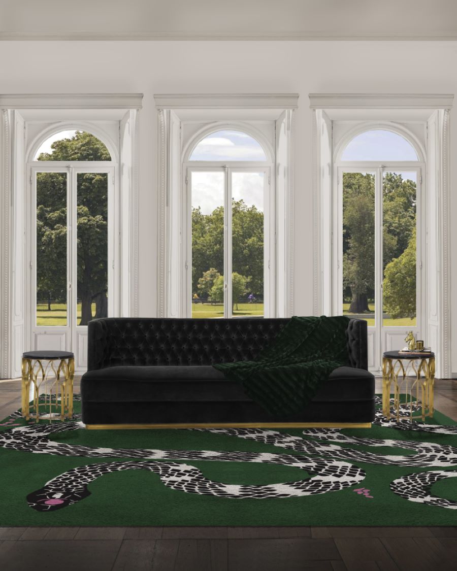 living room with green rug, black sofa and gold and black side table
