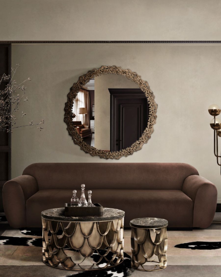 living room whit brown sofa, black and golden coffee tables and wall mirror