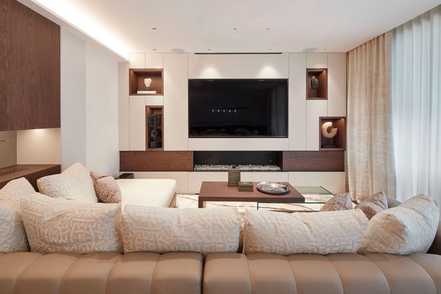 Living room with brown and beige sofa, brown coffee table, tv, decorative elements