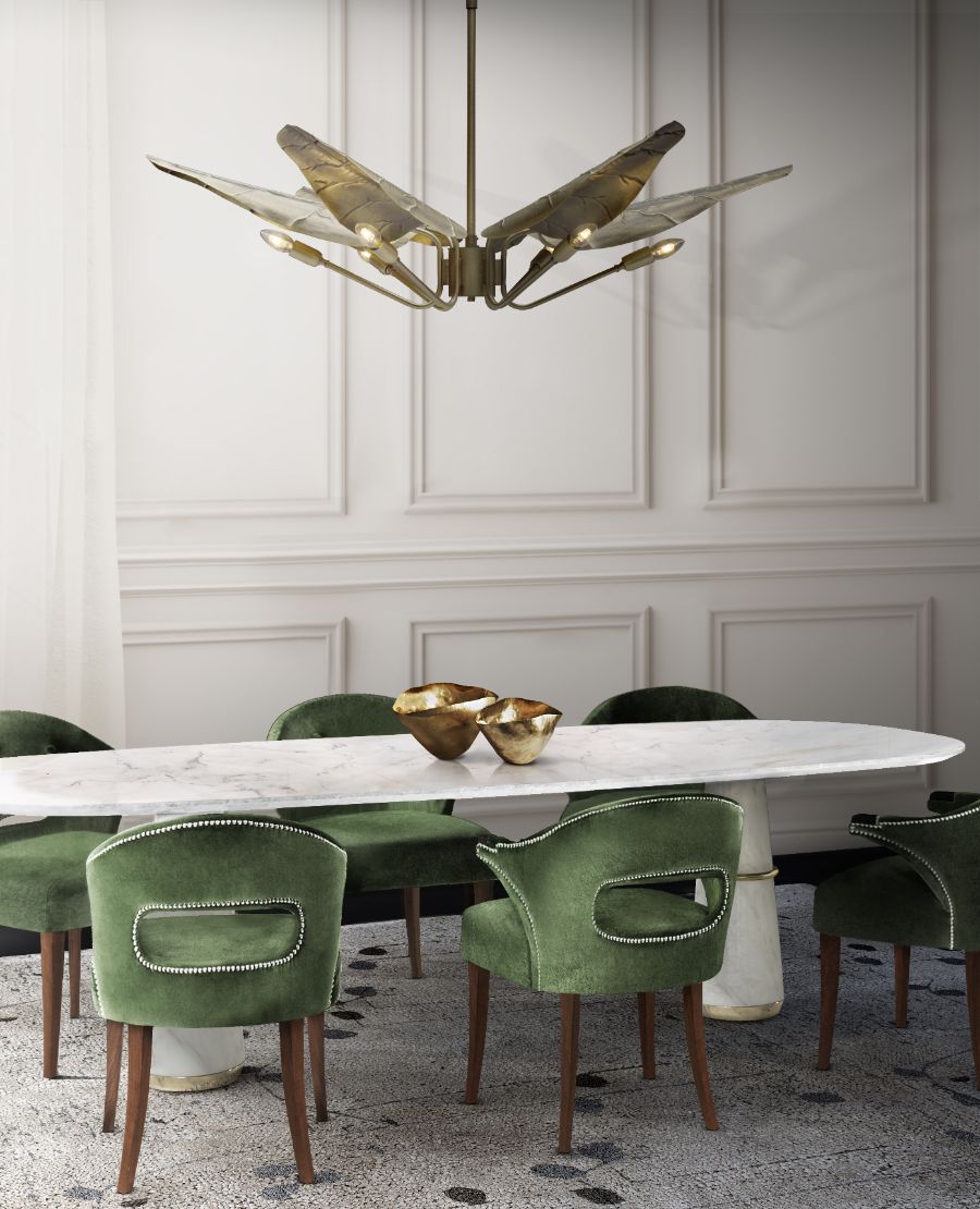 golden suspension lamp, white marble table, green dining chairs